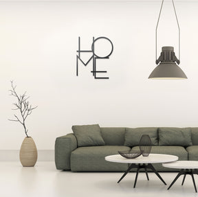 Wanddeko Mesi Home in Feinmatt Pulverbeschichtet in modernem Wohnzimmer mit großen gruenen Sofa